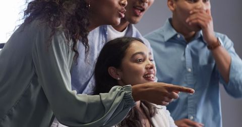 Diverse Team Celebrating Success while Looking at Computer Screen