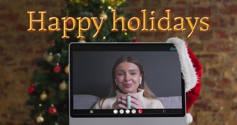 Woman Enjoying Virtual Holiday Celebration with Festive Decorations