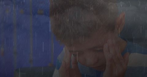 Sick Boy Massaging Temples in Rain Photograph Illustrating Struggles - Download Free Stock Images Pikwizard.com