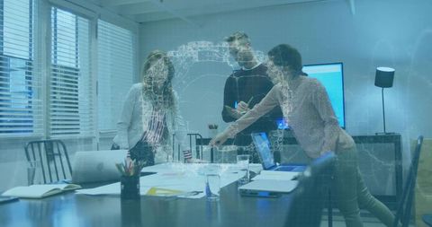 Business team collaborating around conference table with holographic data visualization