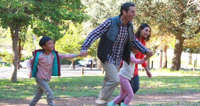 Joyful Family Walking in Park Together - Download Free Stock Images Pikwizard.com