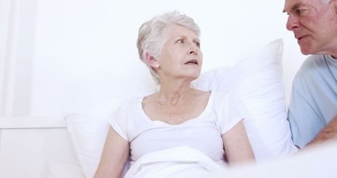 Senior Woman Receiving Care at Home in Bed