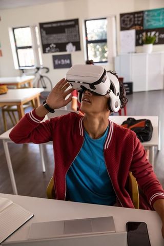 Teen exploring virtual reality headset in modern classroom learning
