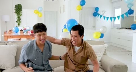 Friends enjoying birthday celebration in cozy living room