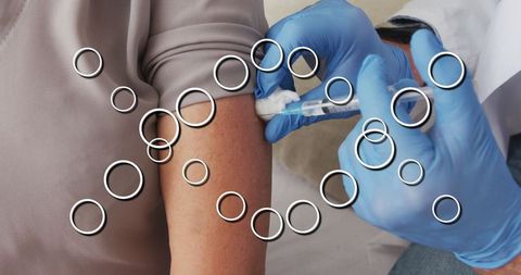 Caucasian doctor administering vaccine with digital dna overlay