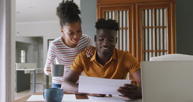 Image of happy african american couple using laptop, paying bills - Download Free Stock Photos Pikwizard.com