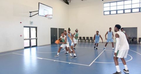 Energetic Basketball Game Among African American Players on Indoor Court