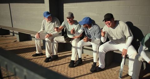 Baseball team laughing in dugout sharing camaraderie and pregame energy