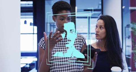 Business professionals discussing technology in modern office