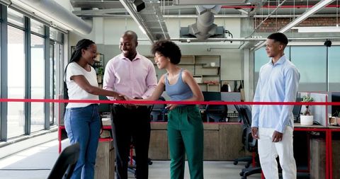 Diverse team celebrating new office opening
