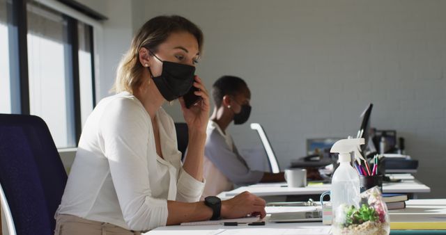 Female Office Workers Wearing Masks and Social Distancing During Work - Download Free Stock Images Pikwizard.com