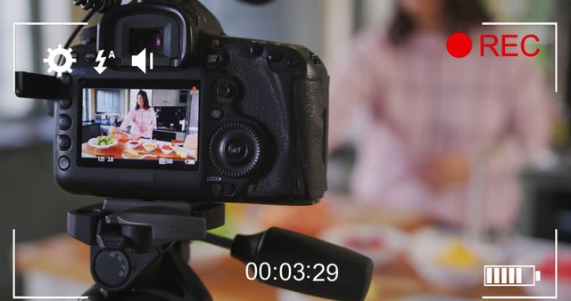 Image of camera viewer digital interface over female culinary vlogger recording vlog at home. global social media, connection and communication concept digitally generated image.