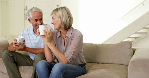 Senior Couple Enjoying Coffee Together on Cozy Couch - Download Free Stock Images Pikwizard.com