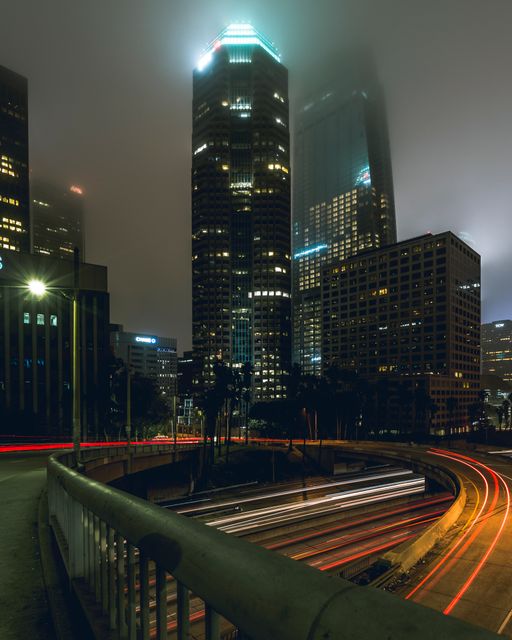 Foggy Night City Skyline with Light Trails on Highway - Download Free Stock Images Pikwizard.com