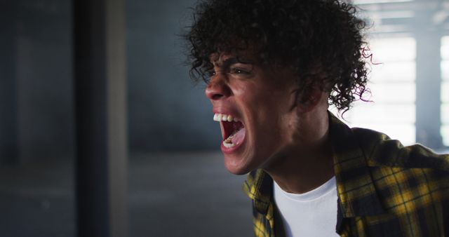 Teenager with Curly Hair Yelling in Anger - Download Free Stock Images Pikwizard.com