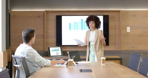 Diverse Team Analyzing Data in a Modern Meeting Room