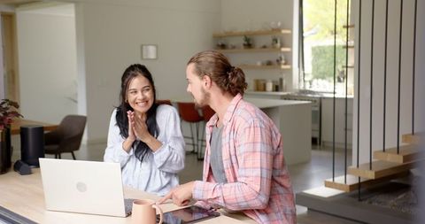 Happy Couple Enjoying Time Together in Modern Home Kitchen