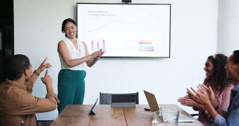 Diverse Coworkers Celebrating Business Success in Modern Office