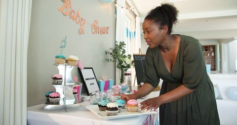 Woman arranging decorations at baby shower celebration