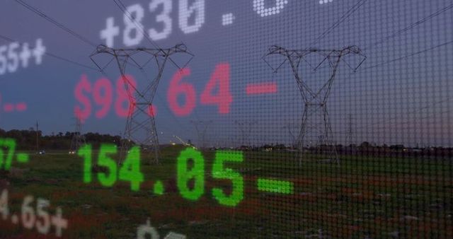 Lattice transmission towers with superimposed stock ticker at dusk