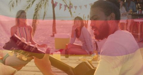 Beach Gathering with Acoustic Guitar and Sunset Vibes