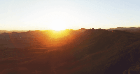 Transparent Sun Setting Over Mountainous Horizon Capturing Scenic Beauty - Download Free Stock Videos Pikwizard.com
