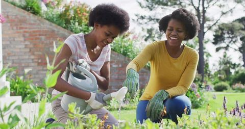 Mother and Daughter Enjoying Backyard Gardening Experience