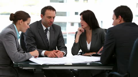 Collaborative Business Meeting with Diverse Team Discussing Documents