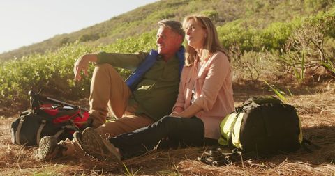 Senior Couple Enjoying a Tranquil Outdoor Adventure in Sunlit Landscape