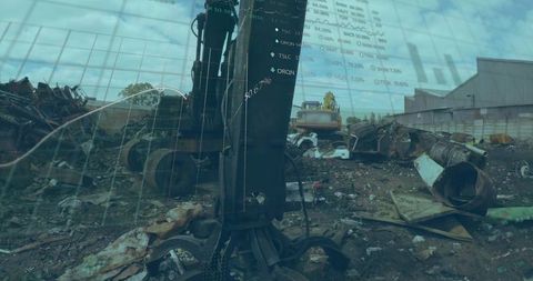 Hydraulic metal grapple handling scrap metal in industrial yard