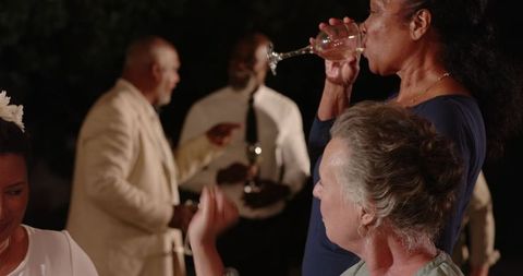 Elegant evening celebration with diverse seniors enjoying drinks