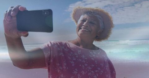 Senior Woman Taking Selfie on Sunny Beach