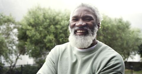Joyful Senior Man Relaxing in Lush Garden Setting