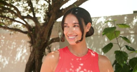 Woman enjoying tranquil garden under dappled sunlight