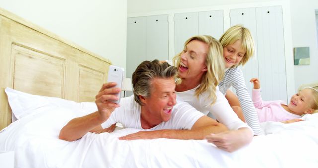 Happy Family Taking Selfies in Bed - Download Free Stock Images Pikwizard.com