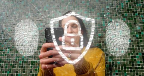 Woman authenticating mobile device using biometric fingerprint and digital shield lock