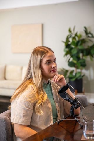 Female podcaster engaged in content creation at home setup