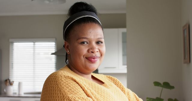 Smiling African American Woman Posing in Kitchen at Home - Download Free Stock Images Pikwizard.com