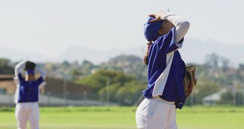 Female Baseball Outfielder Reacting to Missed Catch Wearing Blue Uniform on Grass Field