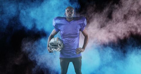 American Football Player in Action with Vibrant Smoke Effects