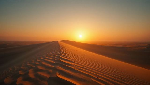 Serene sunset over sand dunes with rippled patterns