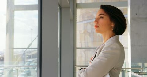 Confident Businesswoman Looking Out Window in Modern Office - Download Free Stock Images Pikwizard.com