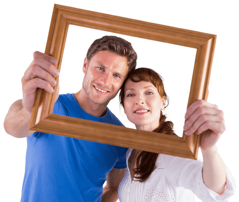 Smiling couple holding wooden frame and looking through