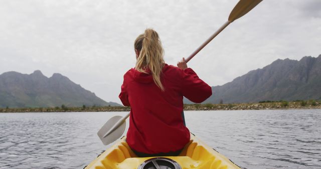Woman kayaking on serene mountain lake - Download Free Stock Images Pikwizard.com