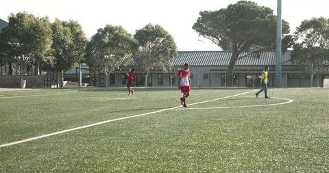 Soccer Player Strolling During Game Near School Arena