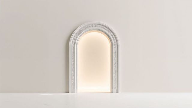 Ornate white arched doorway in minimalistic interior