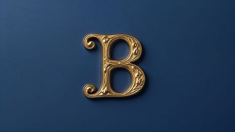 Ornate gold letter b on deep blue background