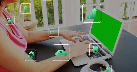 Remote worker typing on laptop with sustainability app icons on veranda workspace
