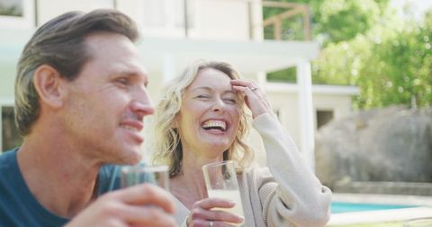 Happy Couple Laughing Enjoys Outdoor Drink