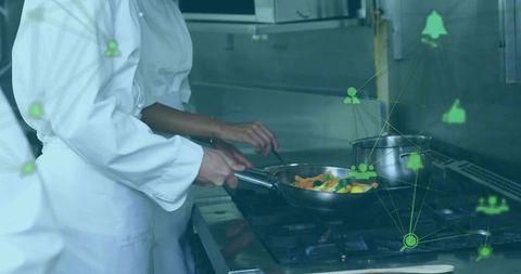 Professional chefs utilizing technology in modern kitchen